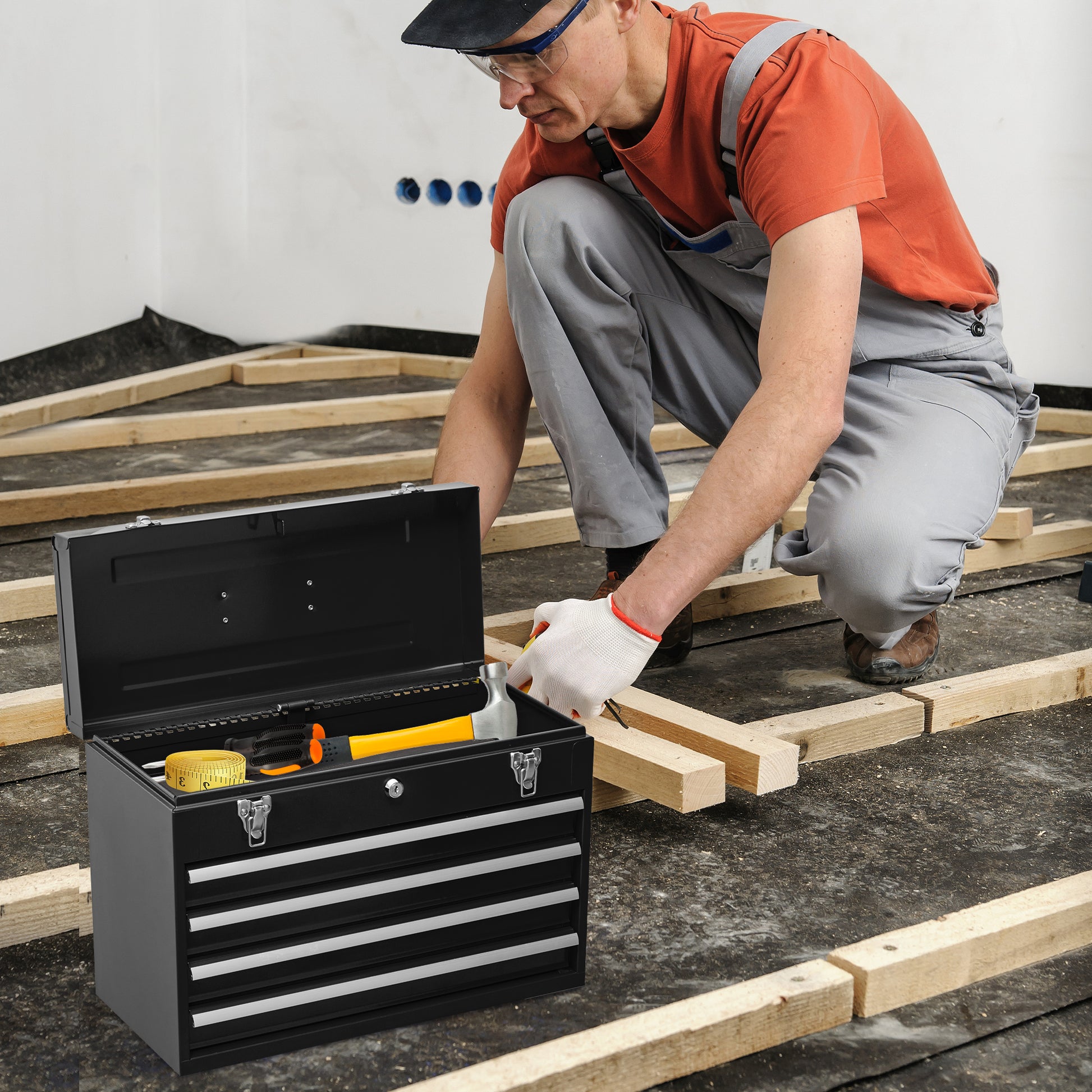 Black metal toolbox with yellow hammer and tape measure inside for home repair