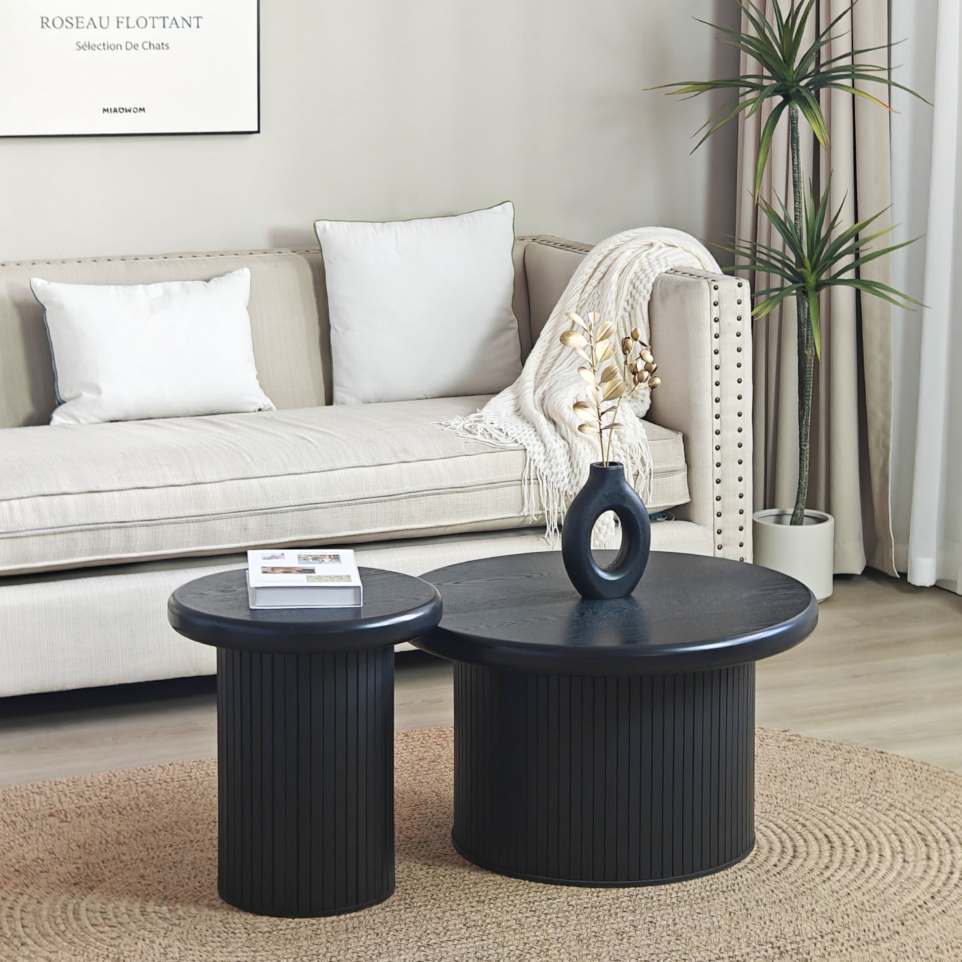 Round black wood nesting coffee tables with fluted bases