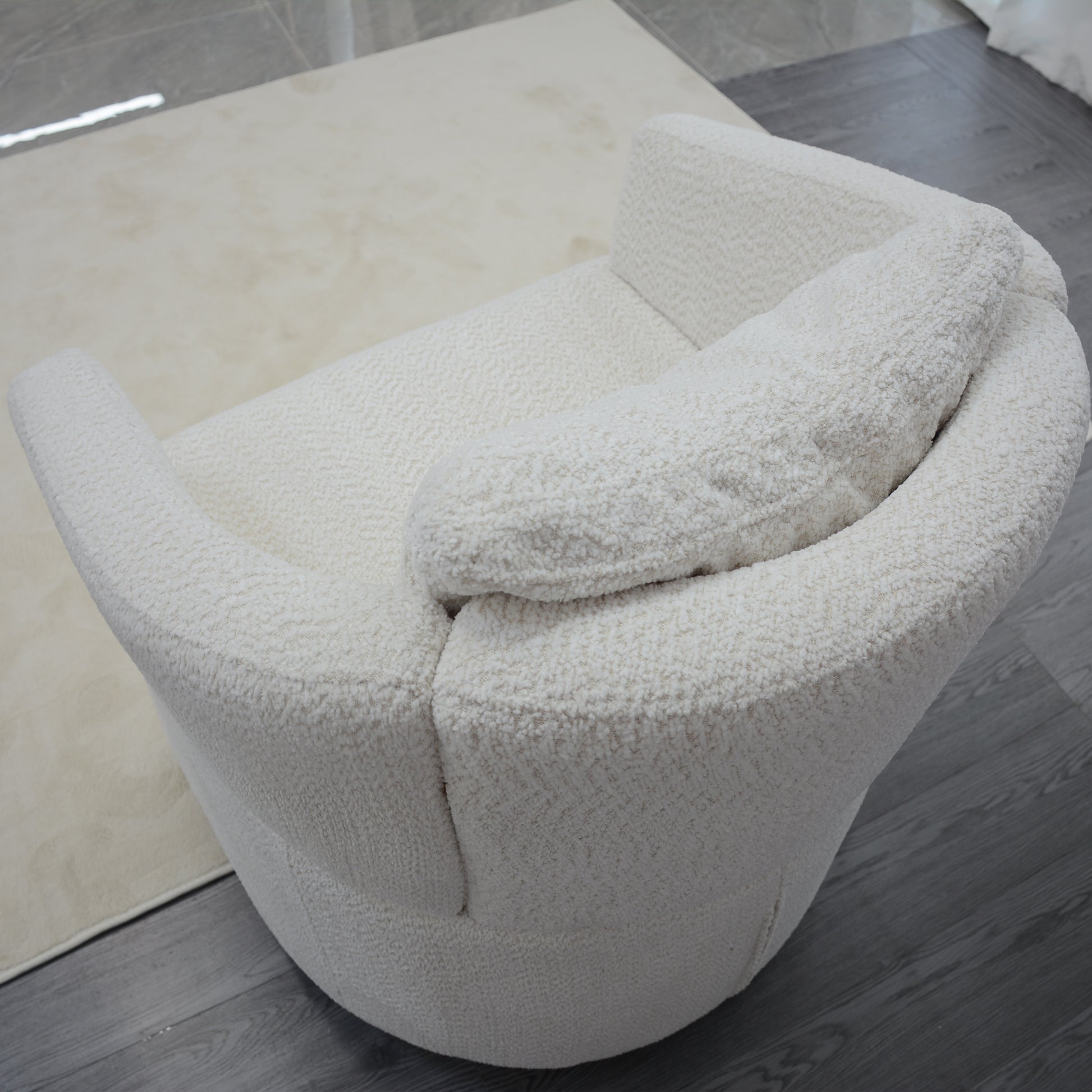 Plush boucle armchair in cream featuring a rounded design and cozy upholstery Perfect modern accent chair