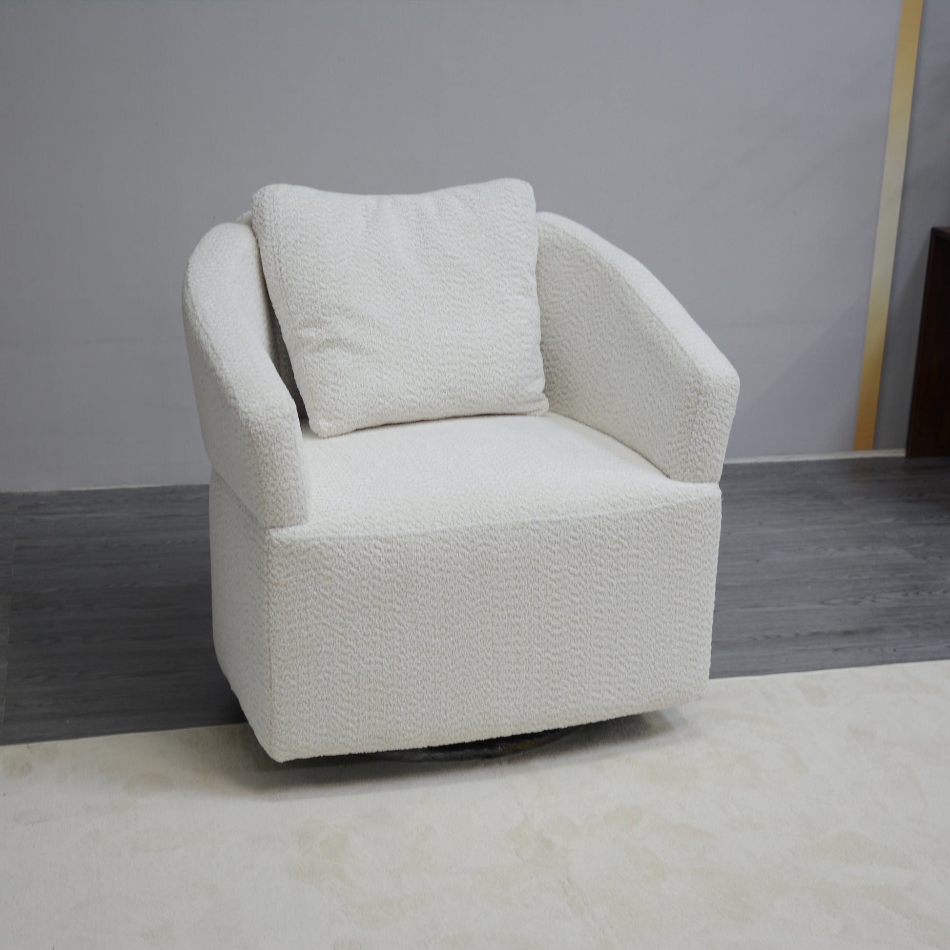 Plush white boucle armchair with a swivel base perfect for cozy living spaces