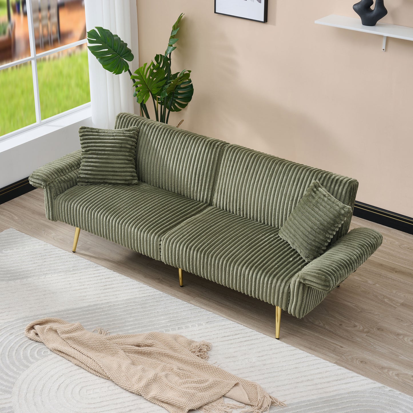 Sage green corduroy sofa with tufted detailing and gold legs