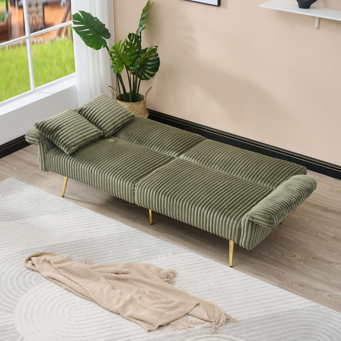 Olive green corduroy sofa bed with plush cushions and gold legs