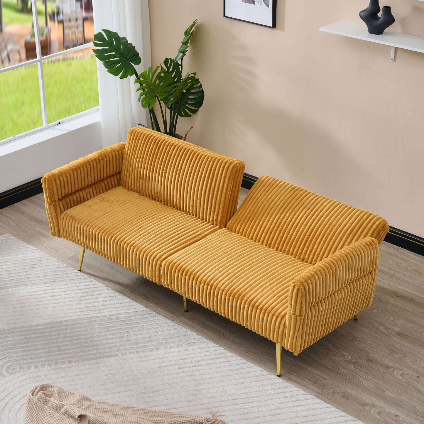 Luxurious mustard yellow corduroy sofa with plush texture and gold legs