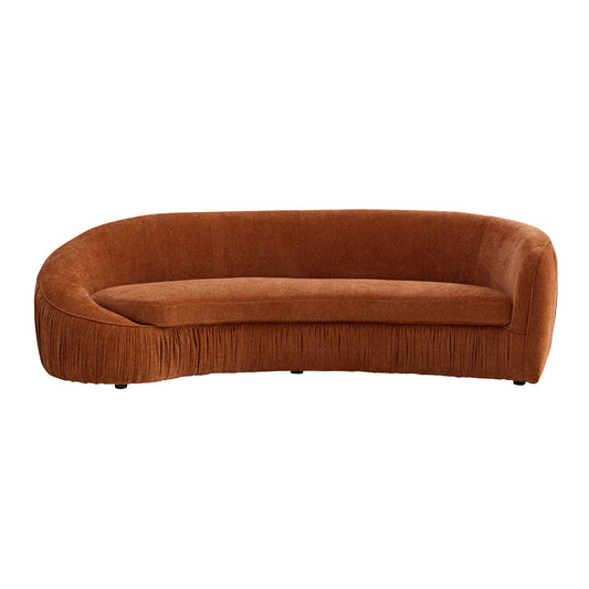 Curved terracotta velvet sofa with pleated skirt and rounded arms