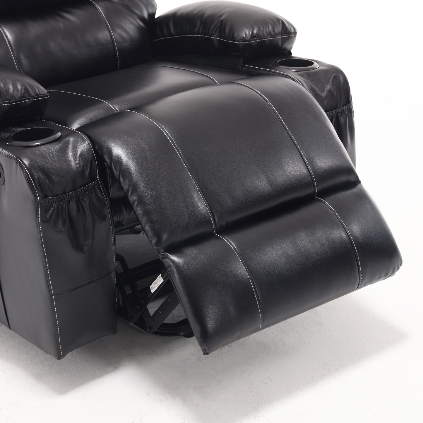Closeup of a black leather reclining chair with white stitching and a cupholder