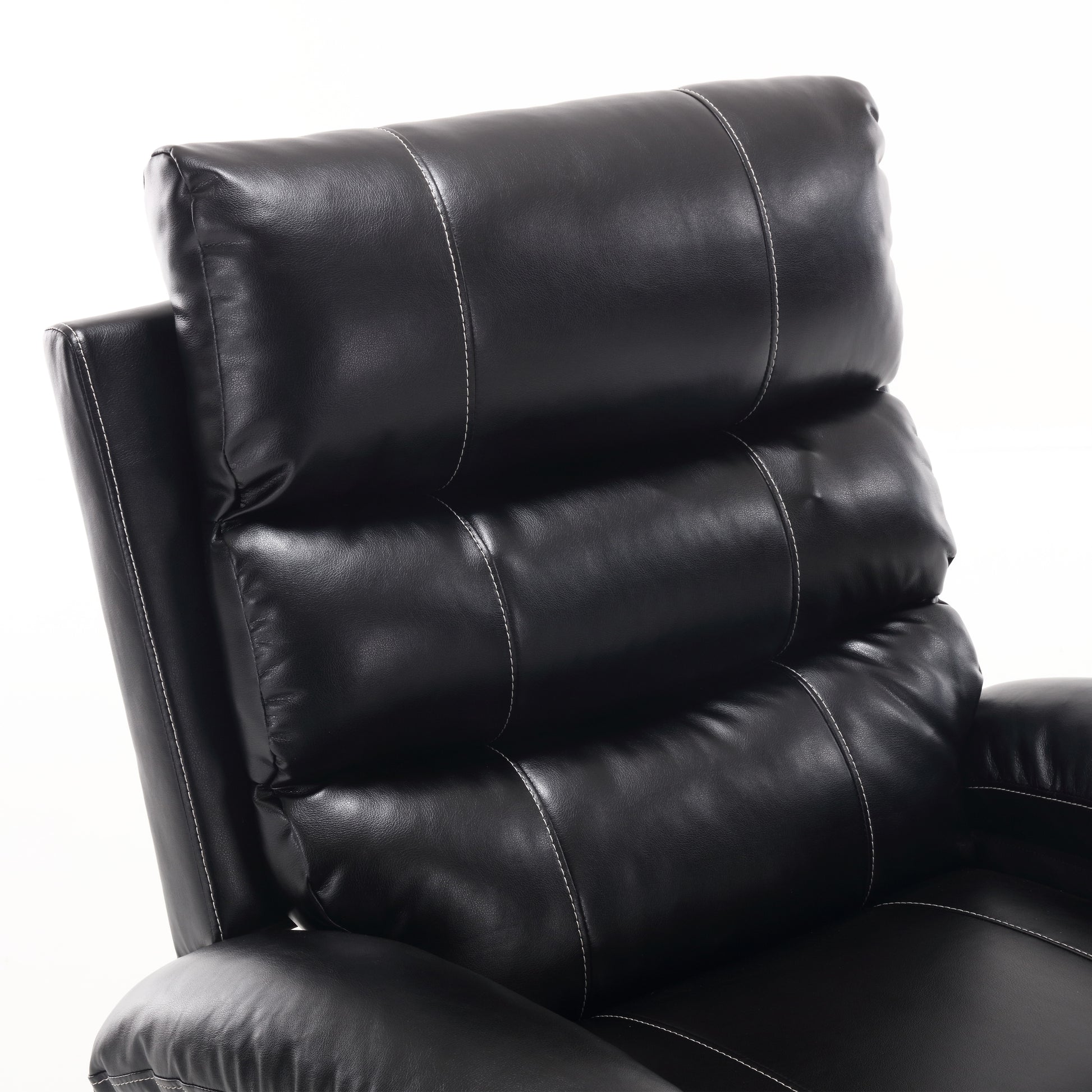 Closeup of a black faux leather recliner headrest with white stitching details