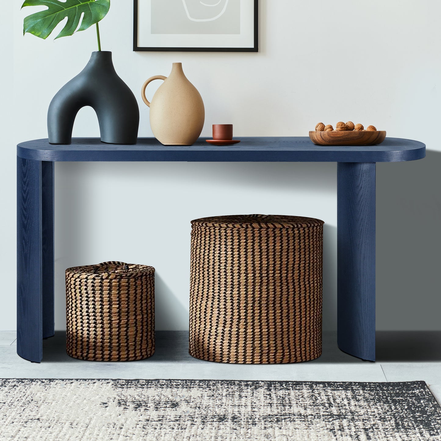 Dark blue modern console table with curved legs holding decorative vases