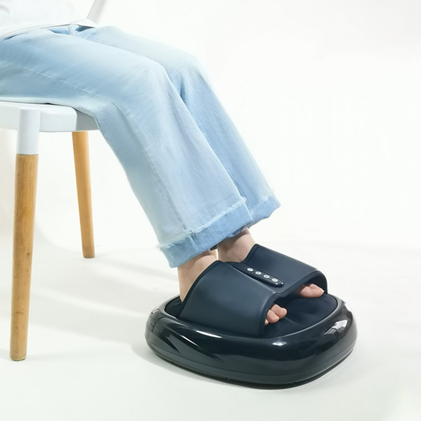 Dark blue foot massager with textured surface and control panel used while sitting
