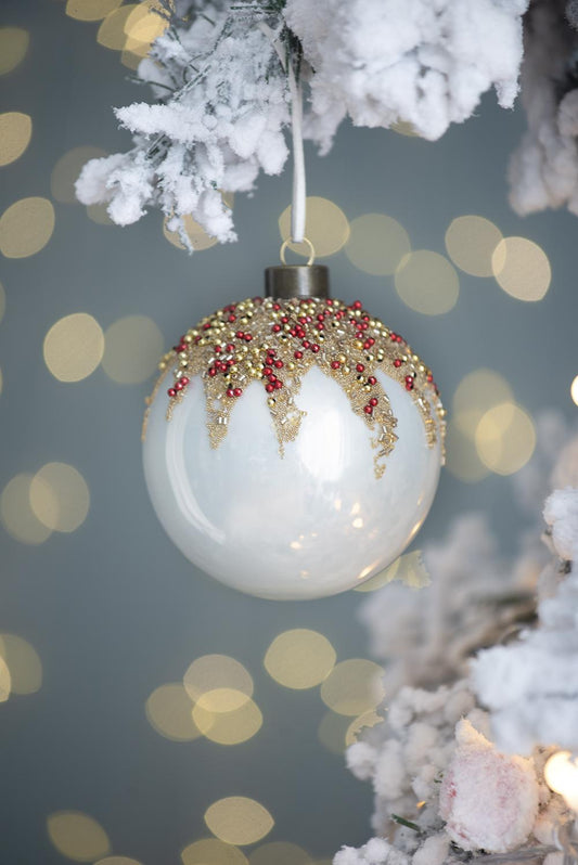 White glass Christmas bauble with gold and red bead accents