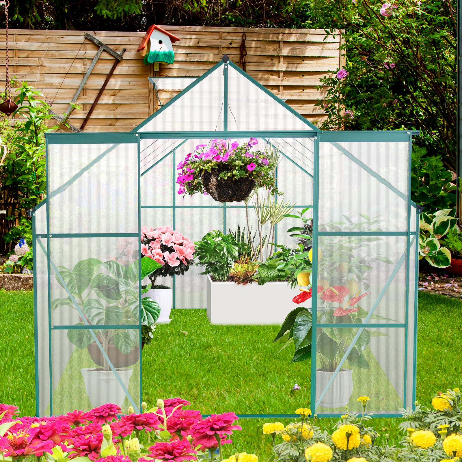 Green polycarbonate greenhouse filled with vibrant pink petunias azaleas and tropical plants