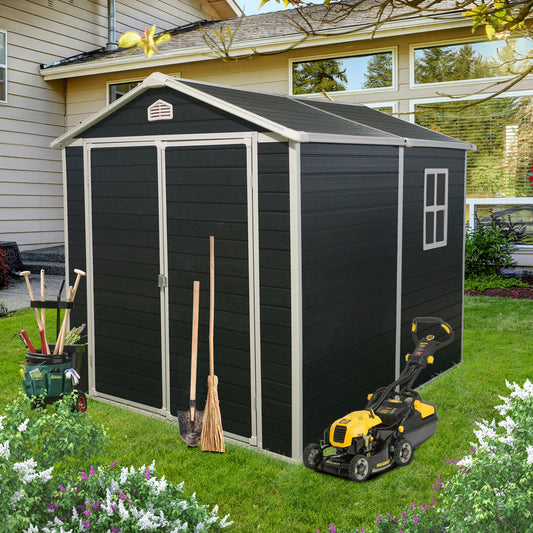 Black resin garden shed with double doors and a window featuring gardening tools and a lawn mower