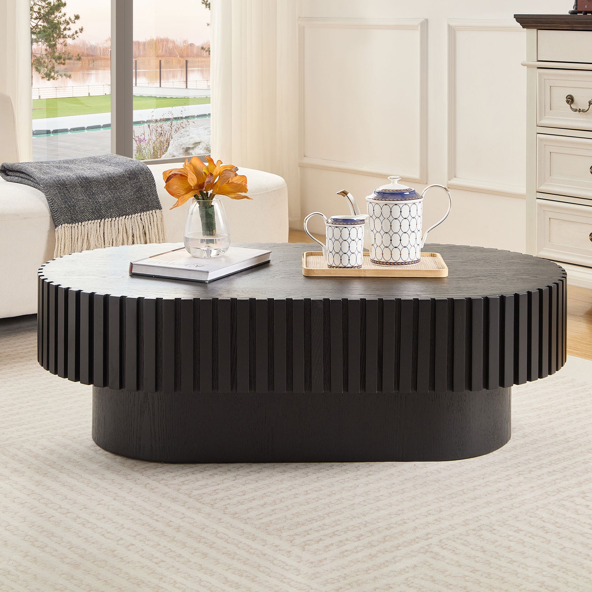 Black fluted coffee table with ornate teapot and mug set perfect for modern living rooms
