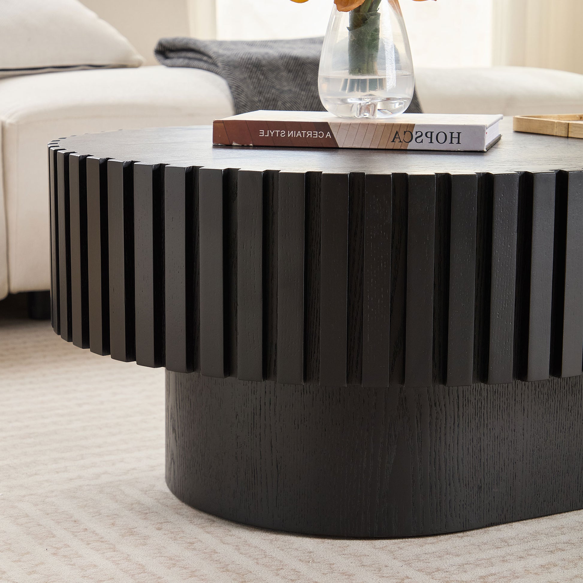 Dark wood fluted coffee table with a book and vase for modern living rooms
