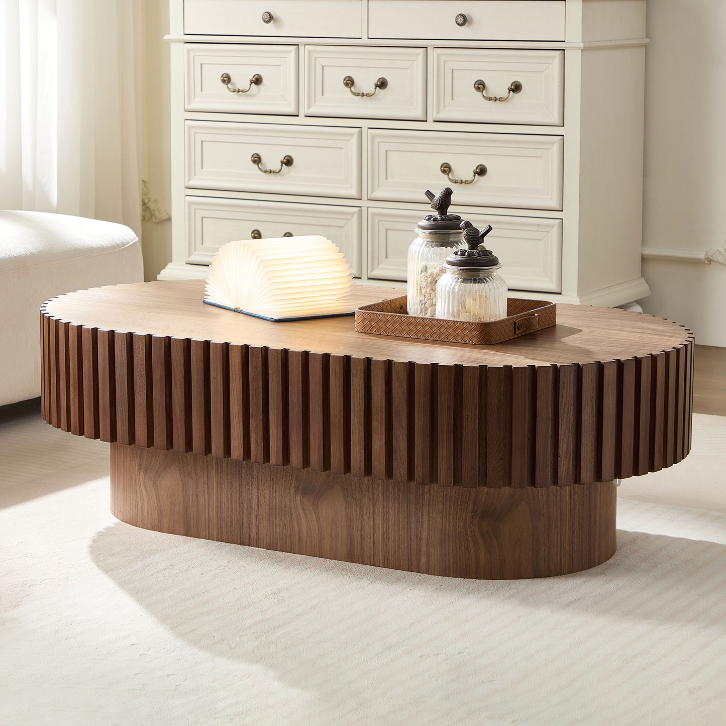 Oval wooden coffee table with ribbed side detail and minimalist design