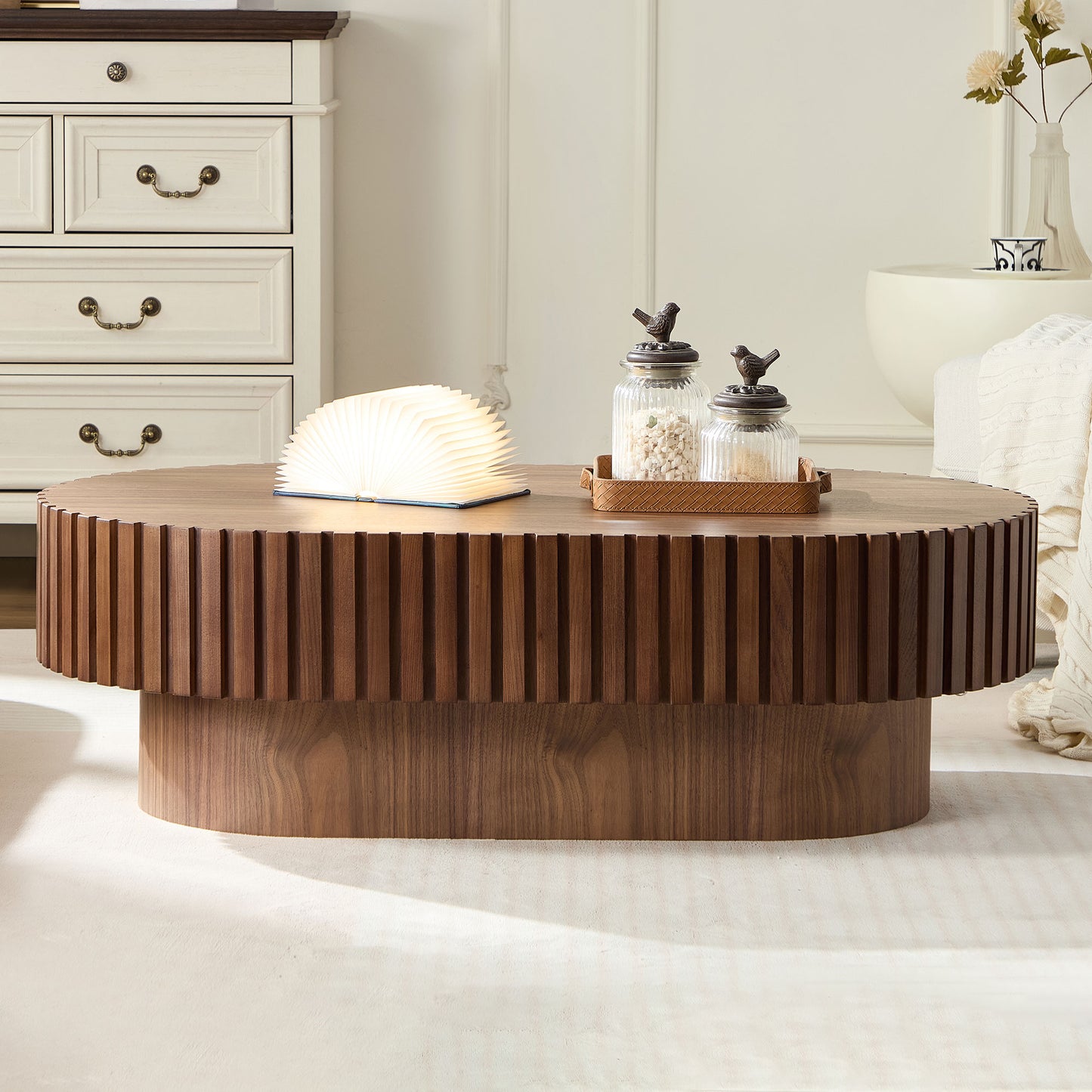 Round walnut wood coffee table with fluted detailing and a modern cylindrical base