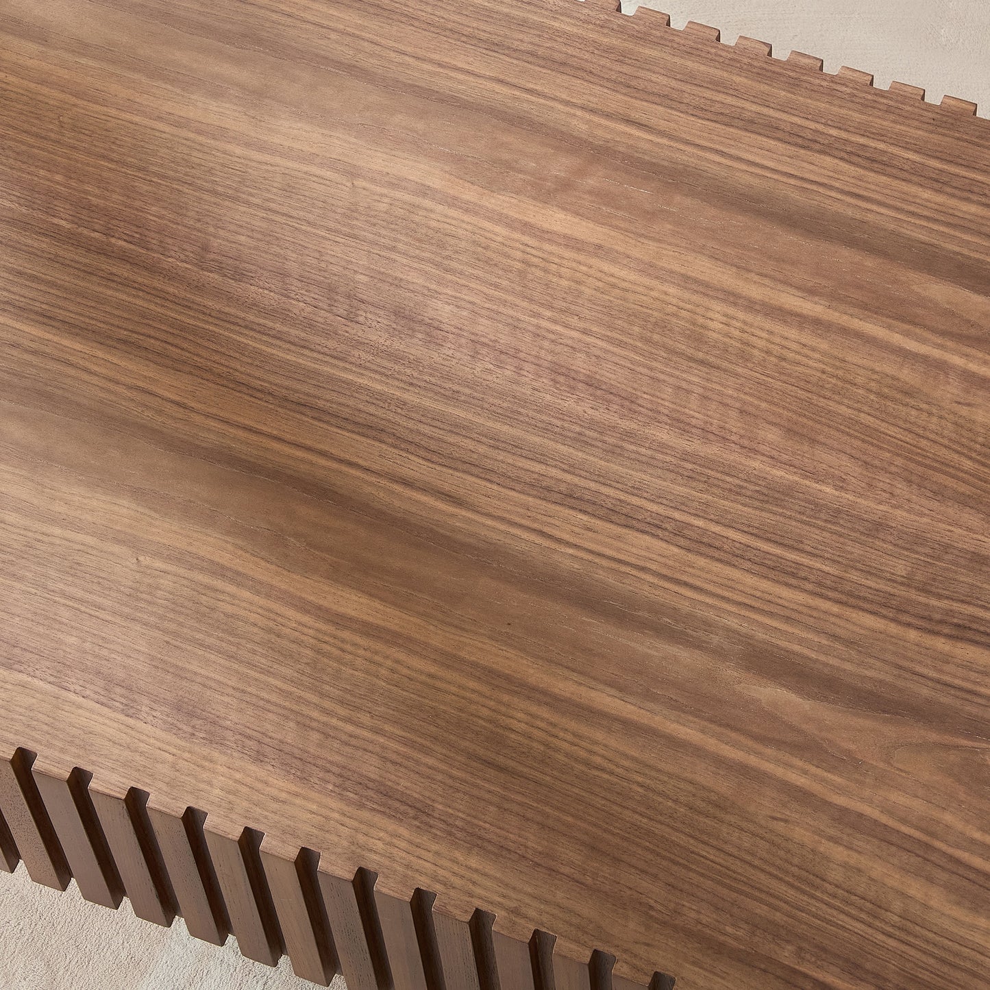 Closeup of a rich walnut wood dining table with visible grain patterns