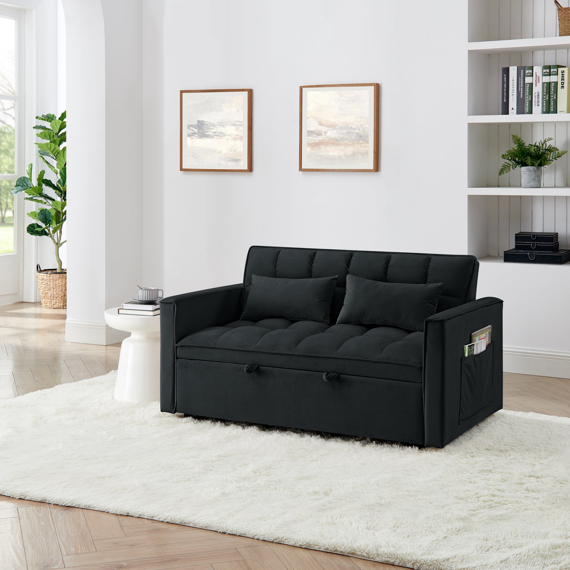 Dark gray tufted sofa bed with two pillows and side pocket storage