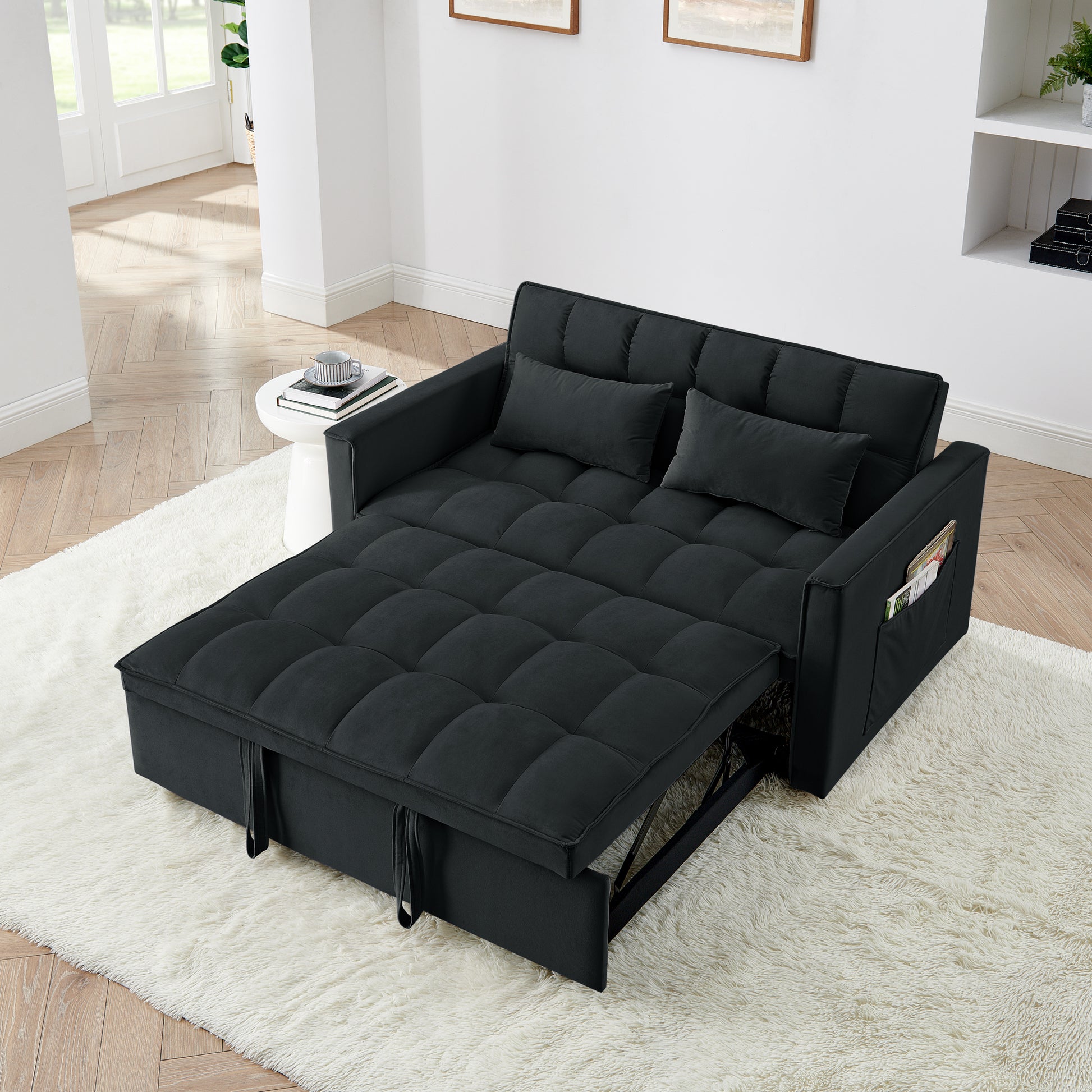 Black upholstered sofa bed with tufted cushions ideal for small living spaces