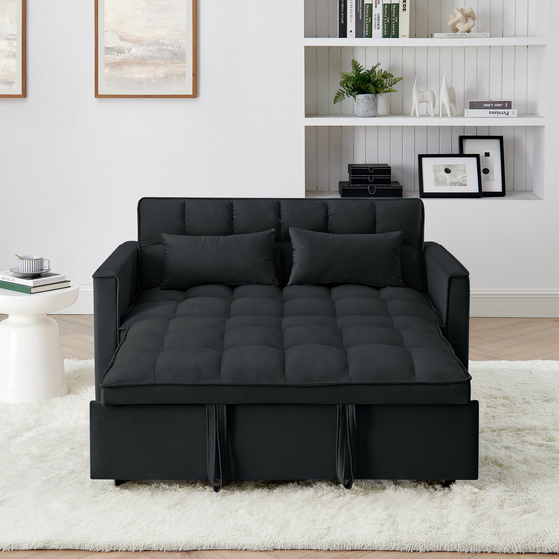 Dark gray convertible futon sofa bed with tufted cushions and two throw pillows