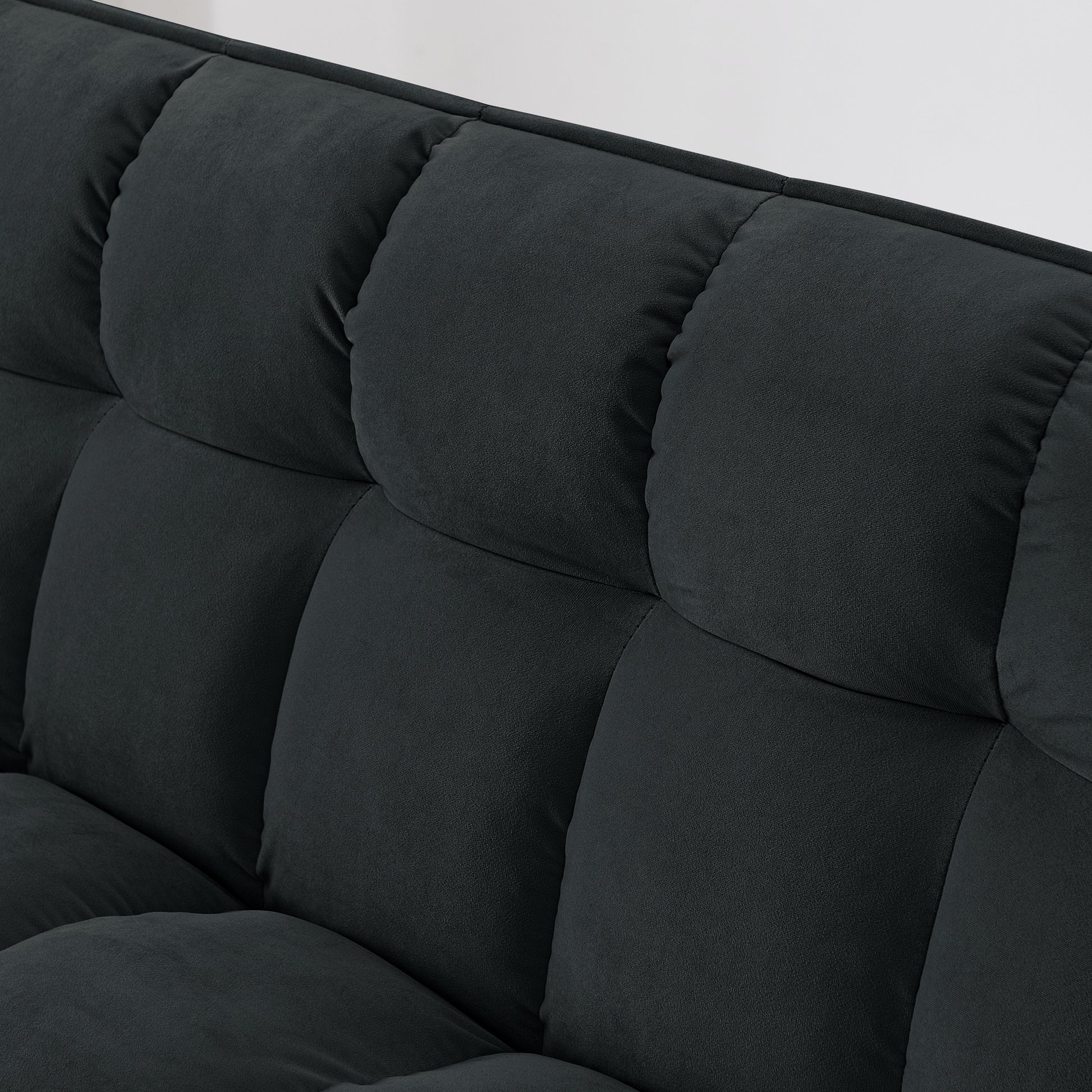 Closeup of tufted dark grey fabric sofa plush cushions for comfort