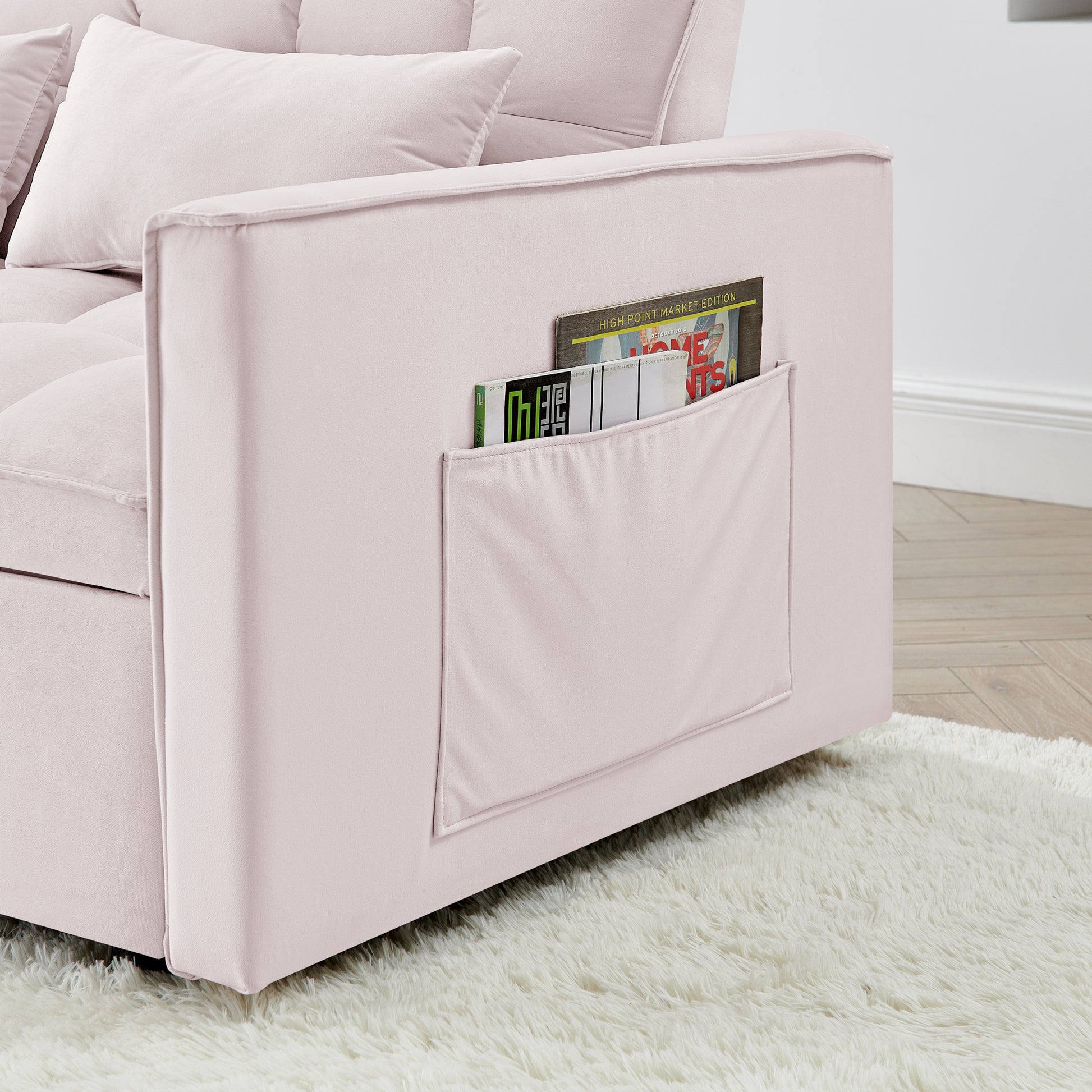 Soft pink velvet sofa with convenient side pocket for magazines perfect for living room