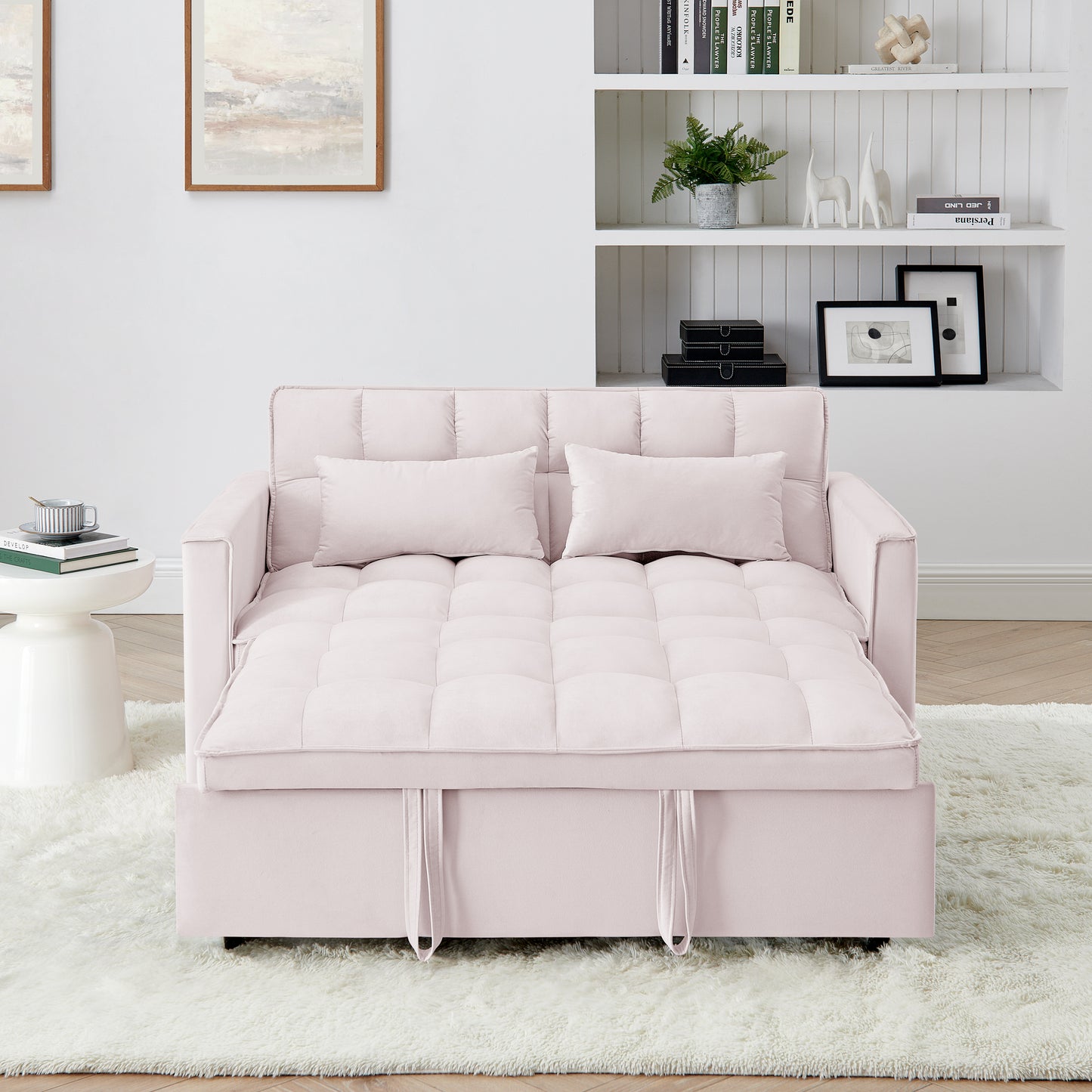 Soft pink velvet sofa bed with tufted cushioning featuring pull straps for conversion