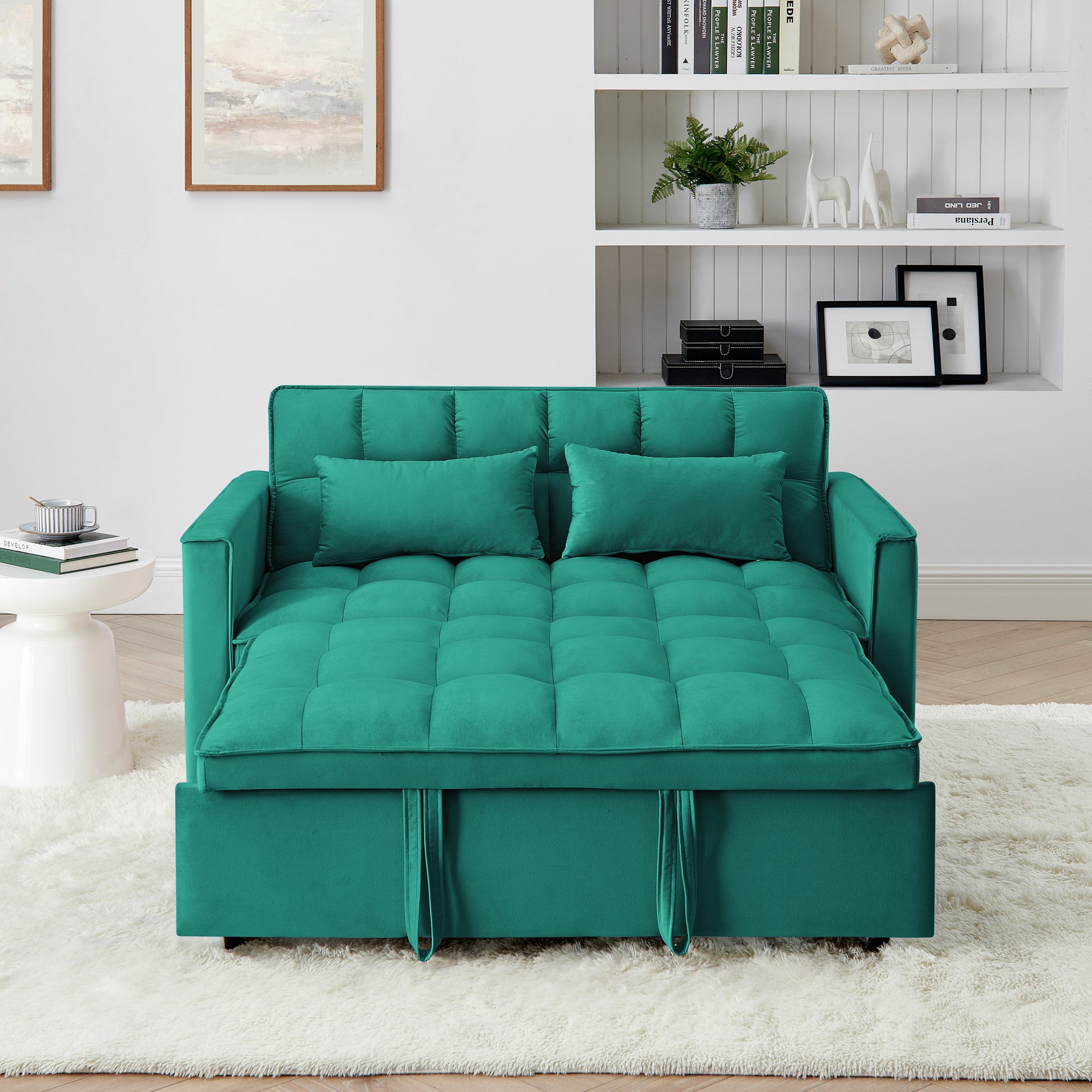Teal velvet convertible sofa bed with tufted cushions and two throw pillows