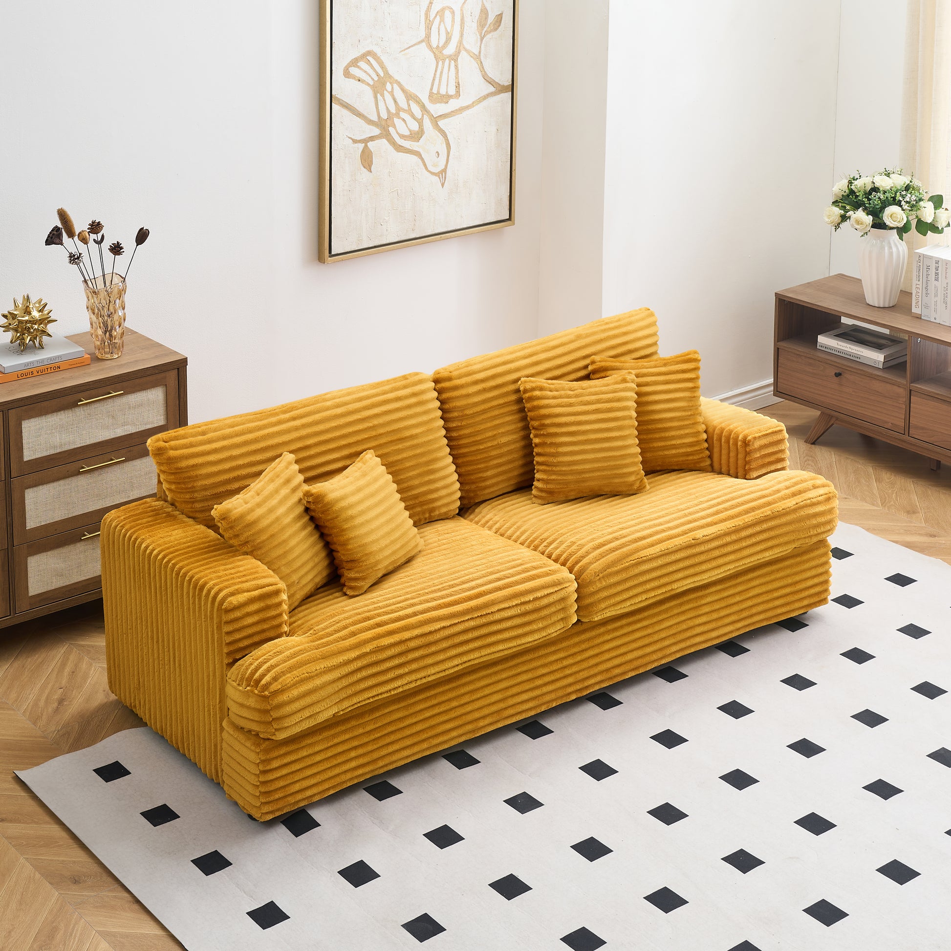Mustard yellow corduroy sofa with plush throw pillows and a textured ribbed design