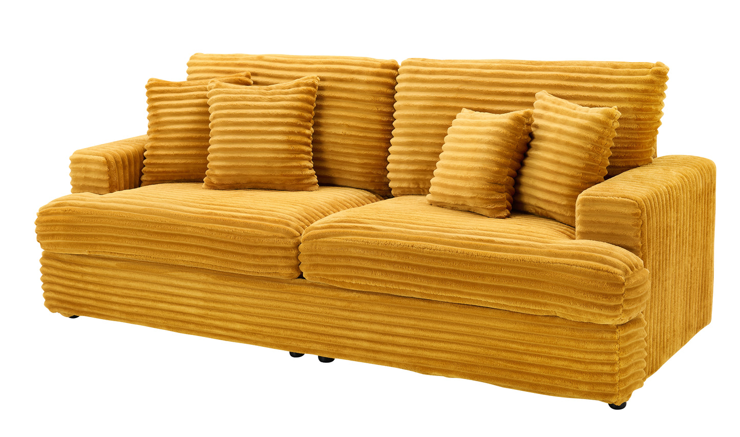 Plush mustard corduroy sofa with matching throw pillows perfect for a cozy living room setting