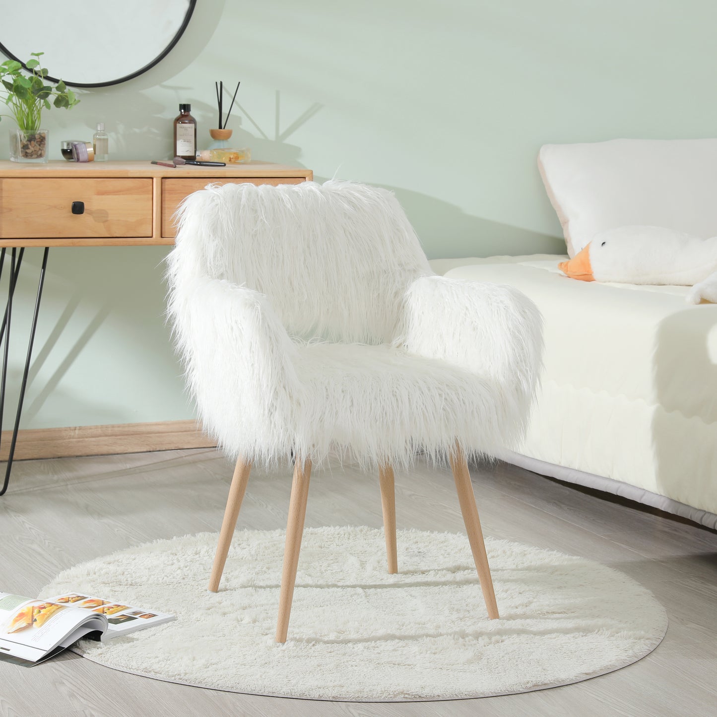 Plush white armchair with wooden legs perfect for a cozy reading nook