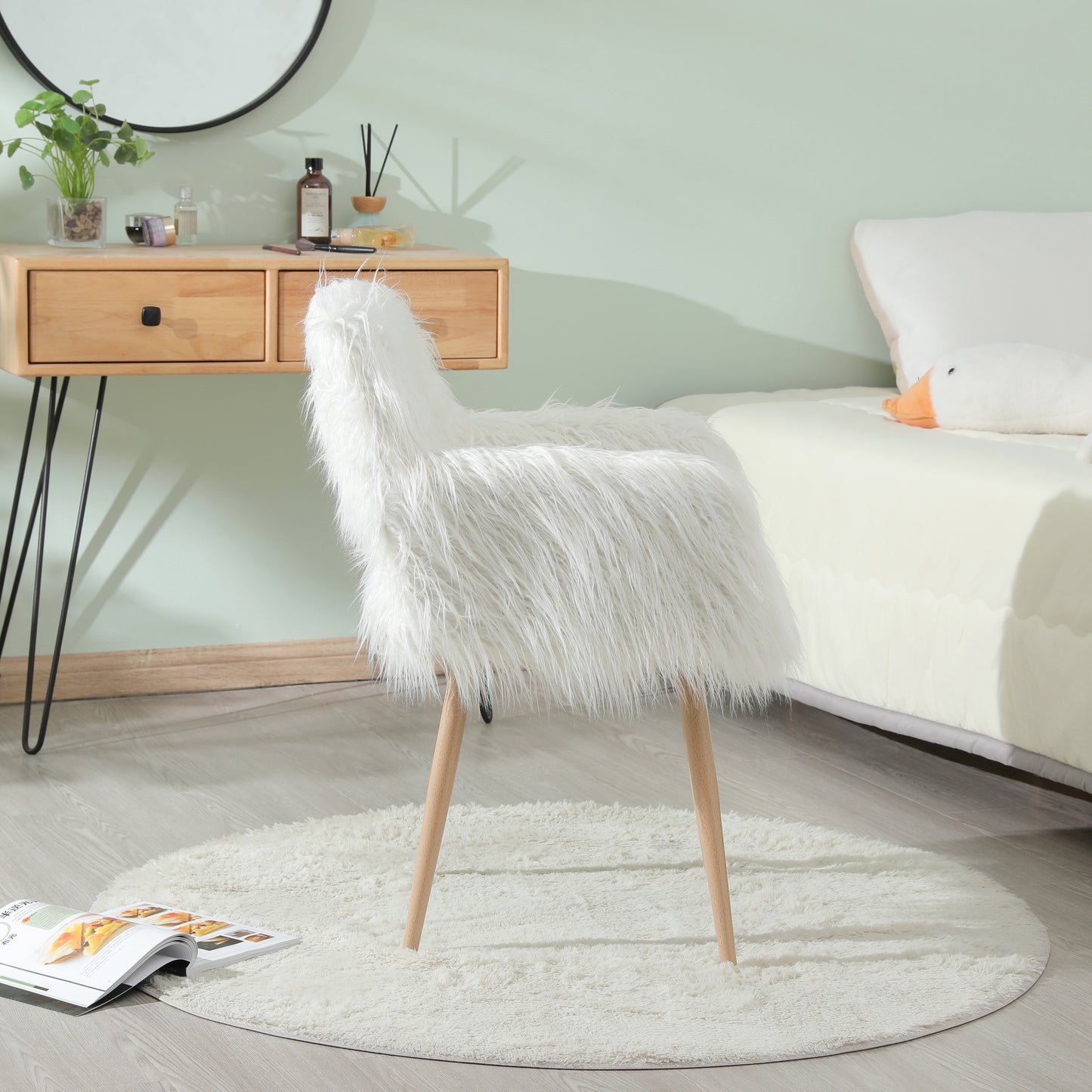 Plush white faux fur accent chair with natural wood legs on a cream shaggy rug