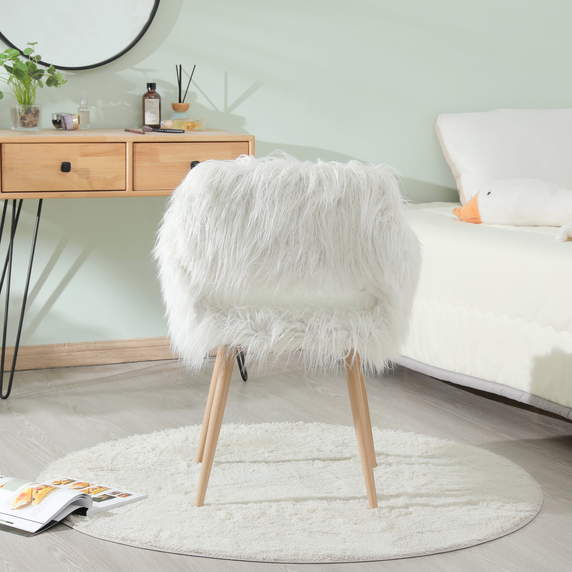 Plush white faux fur accent chair with natural wood legs for a cozy living room