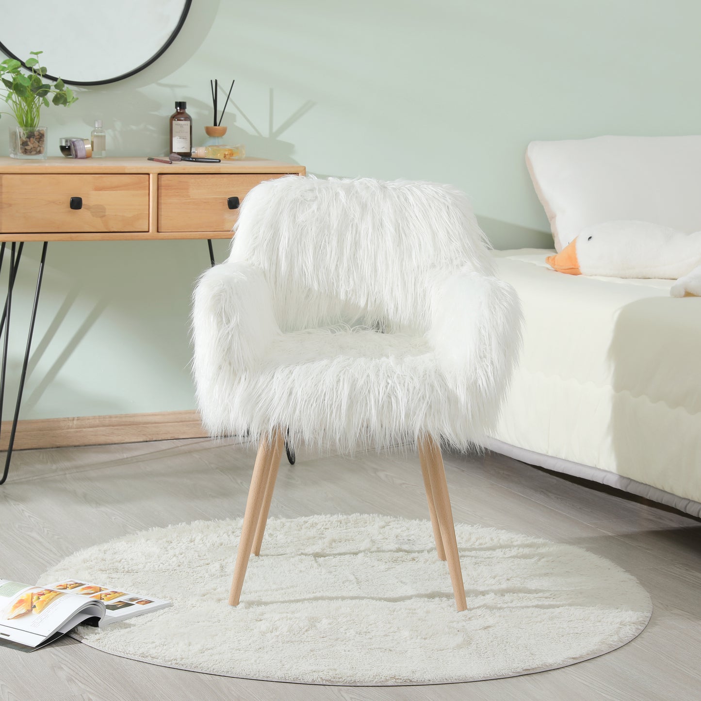 Plush white faux fur accent chair with wooden legs ideal for vanity or living room decor