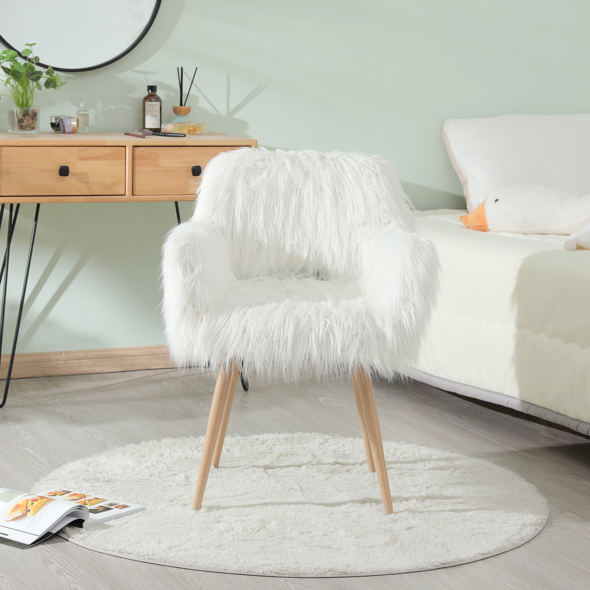 Plush white faux fur accent chair with wooden legs ideal for vanity or living room decor