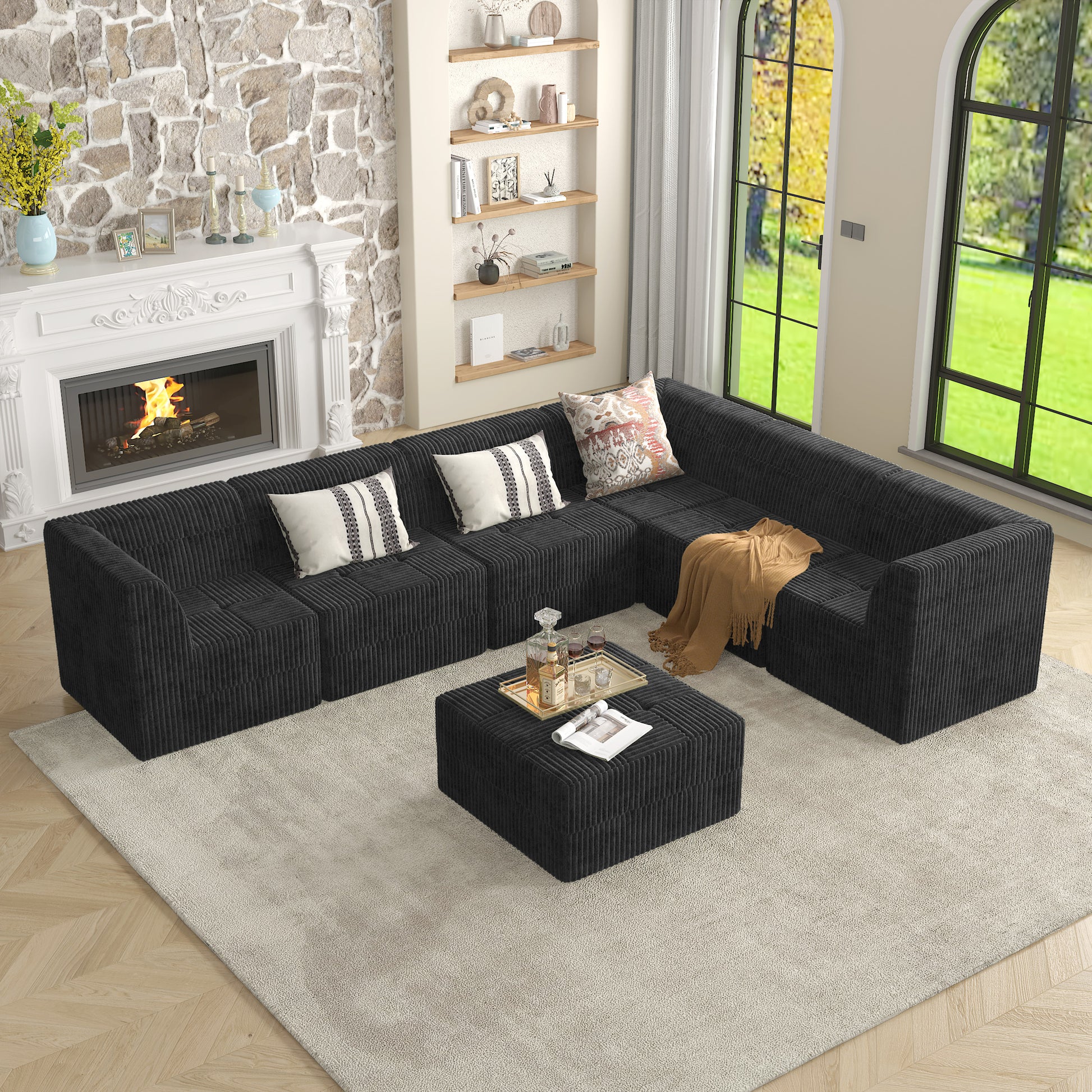 Black corduroy sectional sofa with ottoman and decorative pillows