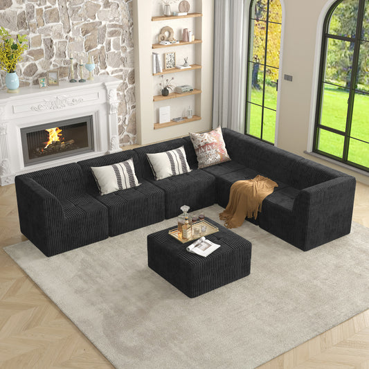 Black corduroy sectional sofa with ottoman and decorative pillows