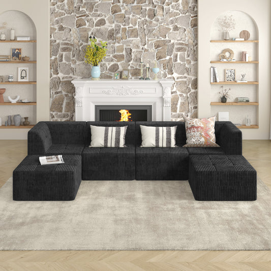 Black corduroy sectional sofa with plush ottomans and decorative pillows