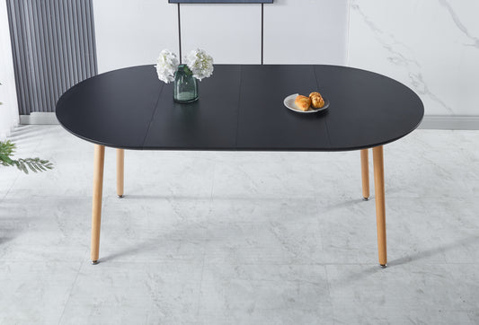 Black oval dining table with light wood legs perfect for modern kitchens