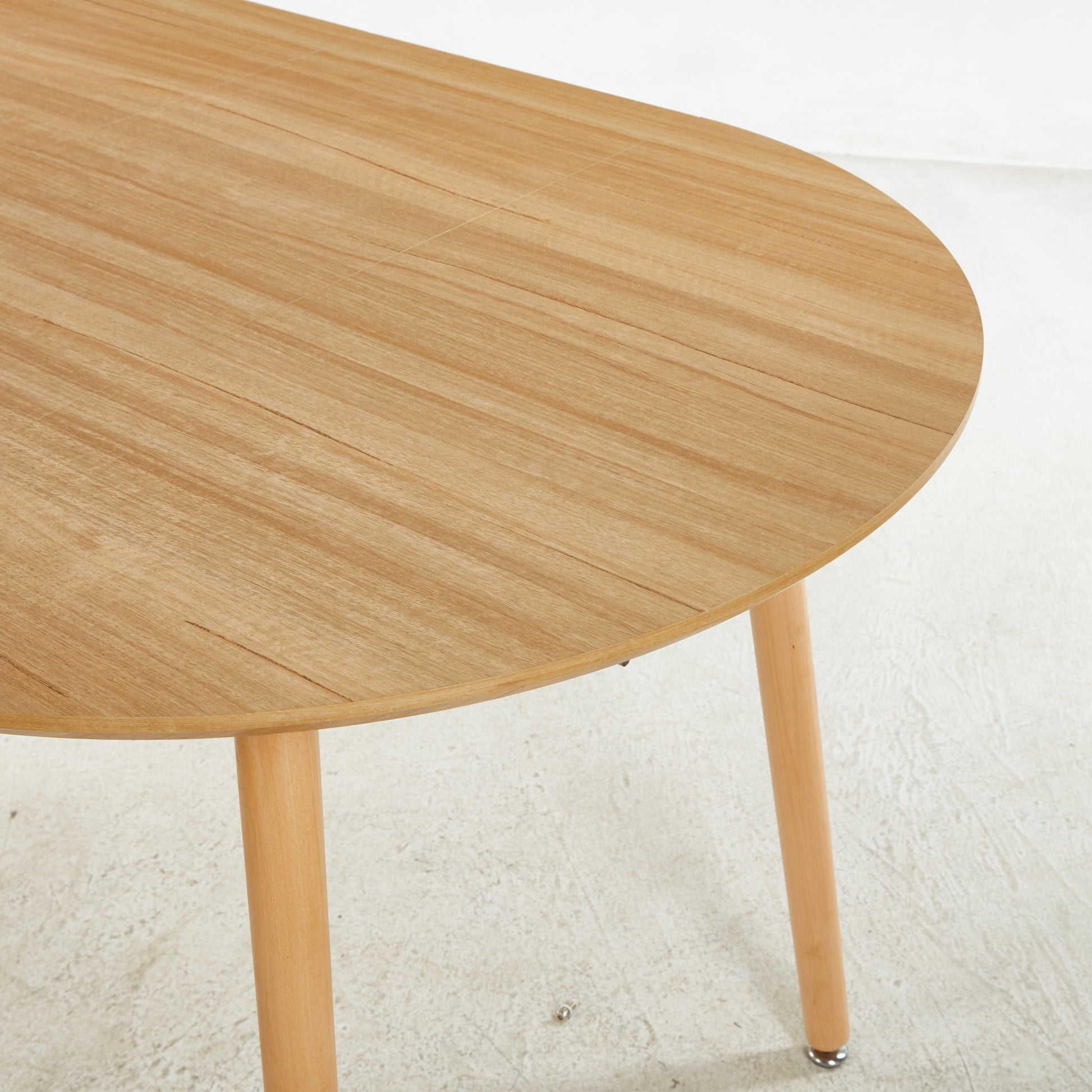 Light oak oval dining table with tapered wooden legs