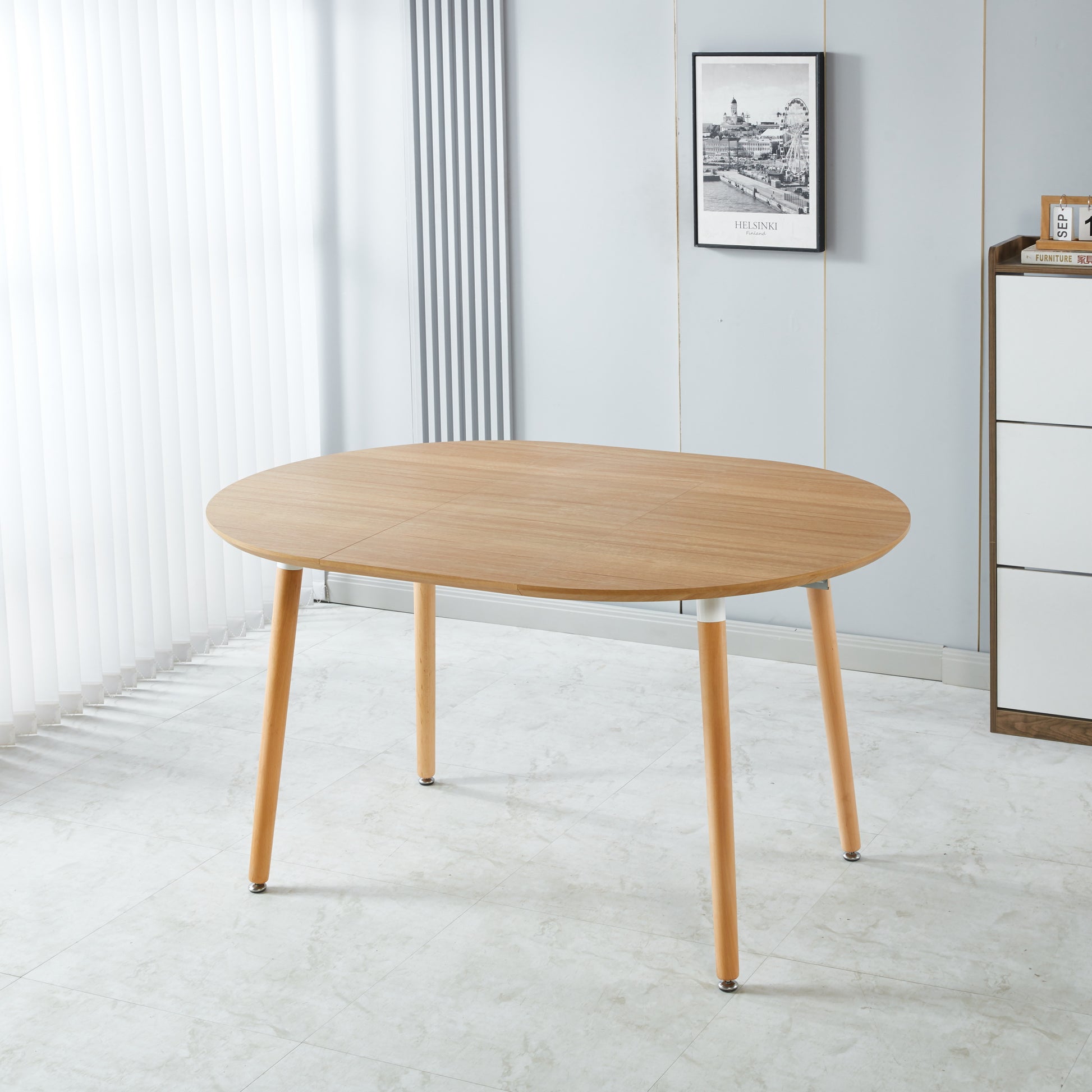 Wooden oval dining table with tapered legs perfect for compact kitchens