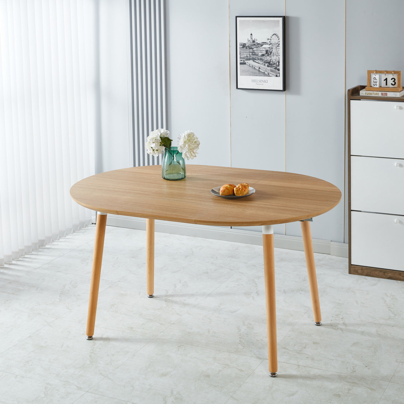 Oval wood dining table with tapered legs perfect for compact kitchens