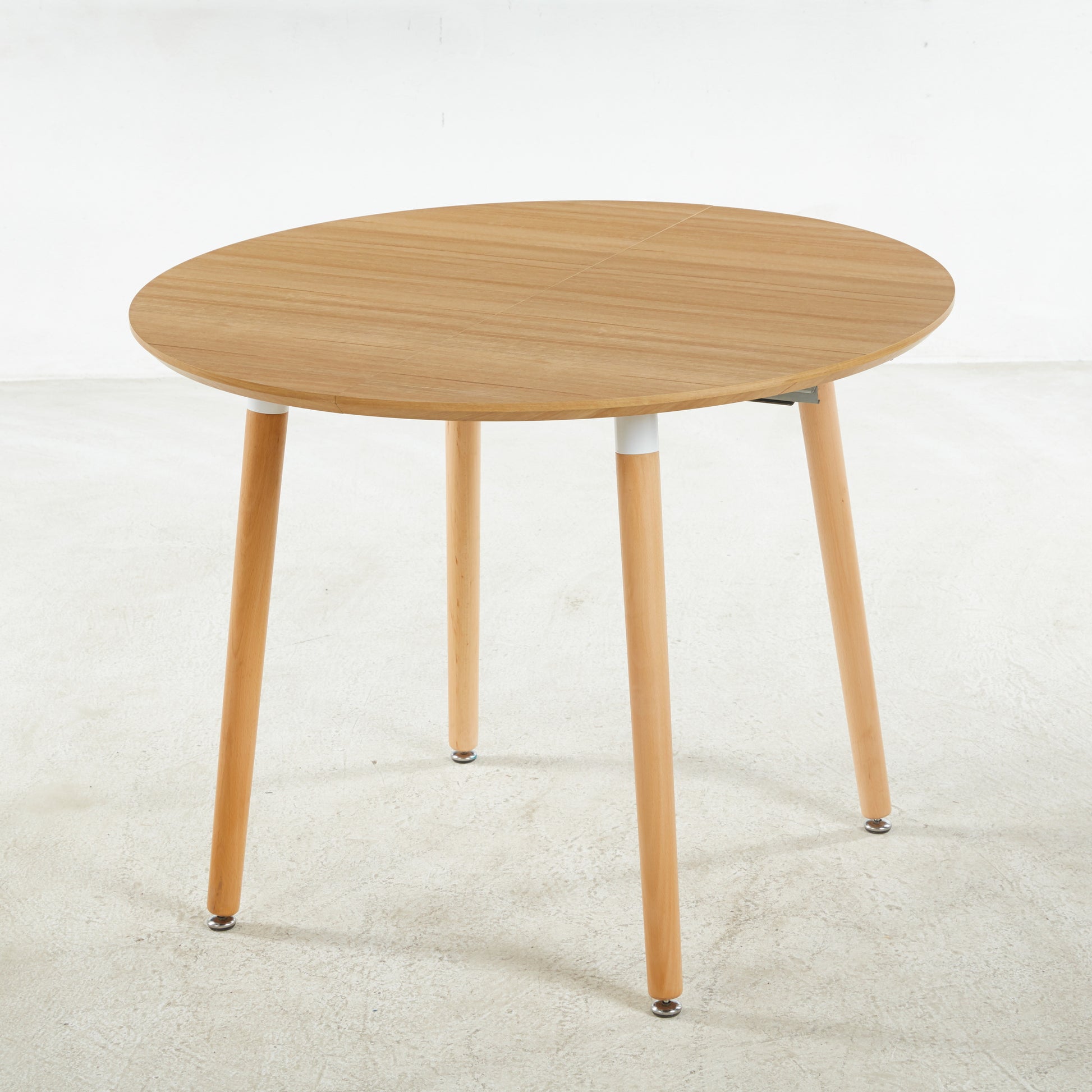 Round oak veneer dining table with light wood legs modern design