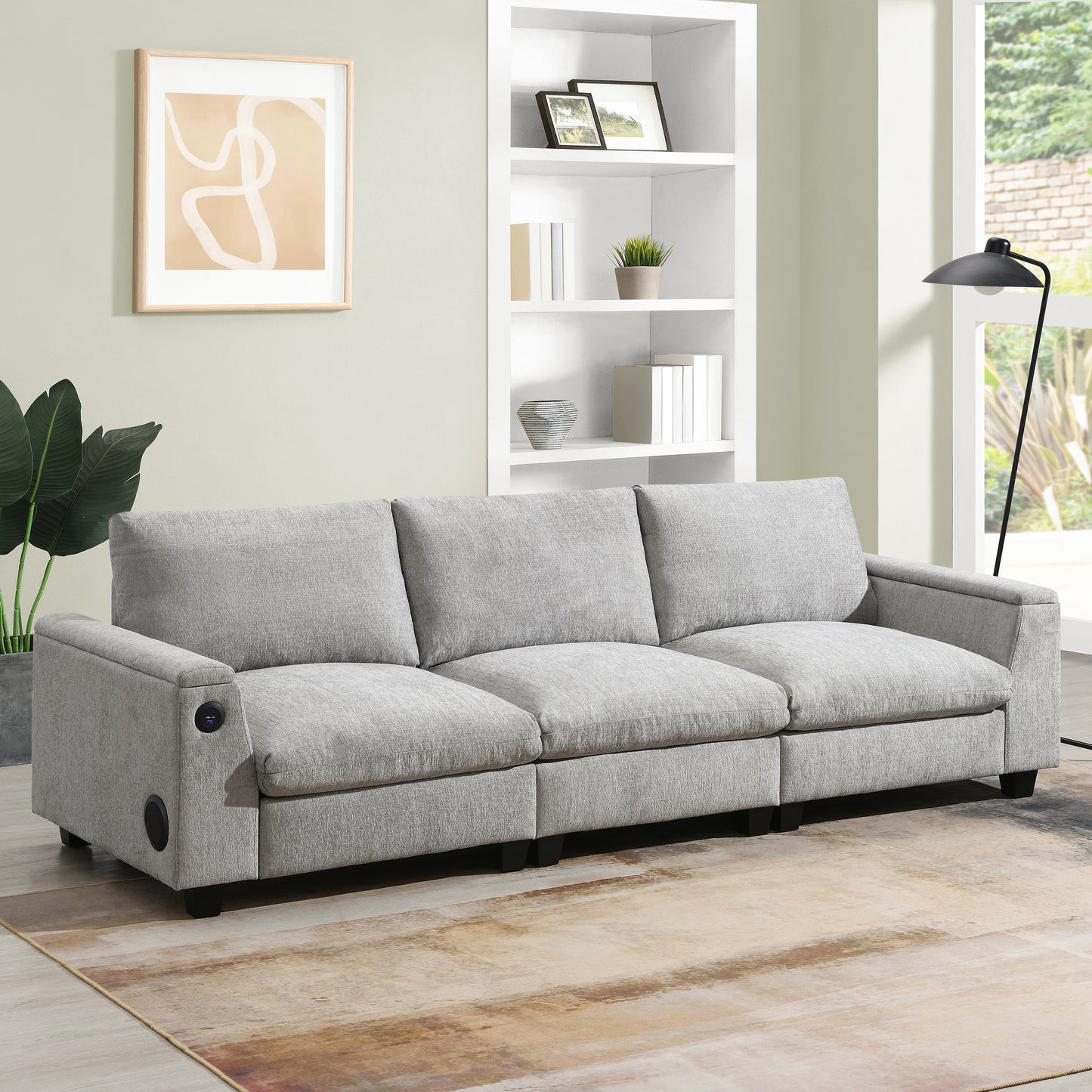 Comfortable light grey fabric threeseater sofa with builtin Bluetooth speaker