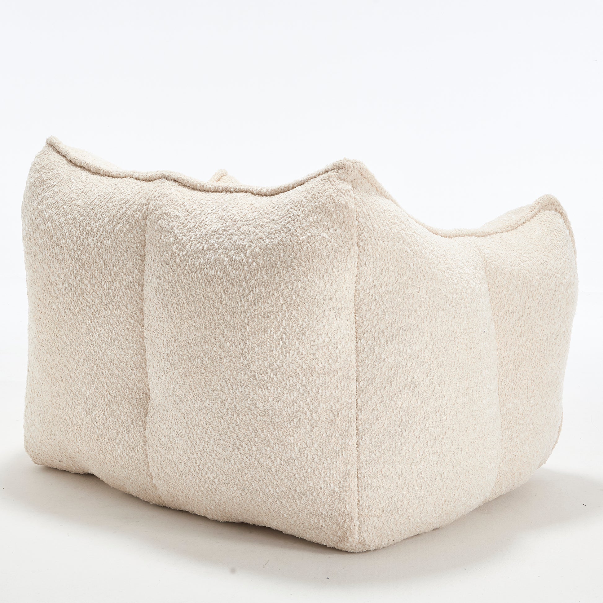 Cream boucle lounge chair with plush textured fabric and curved design for modern seating