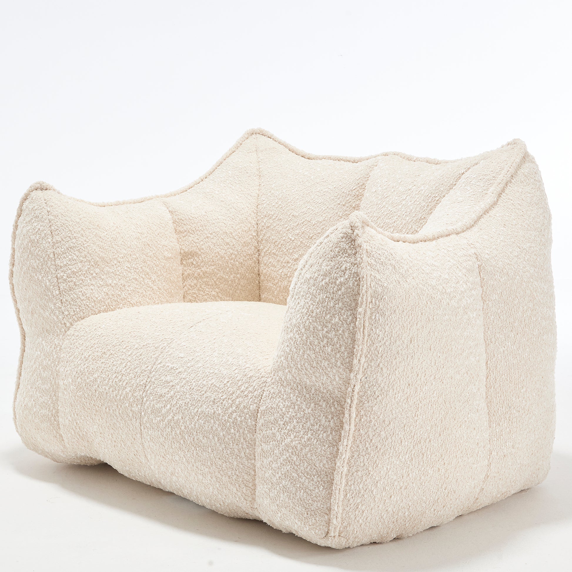 Textured cream boucle armchair with plush enveloping cushions for ultimate comfort