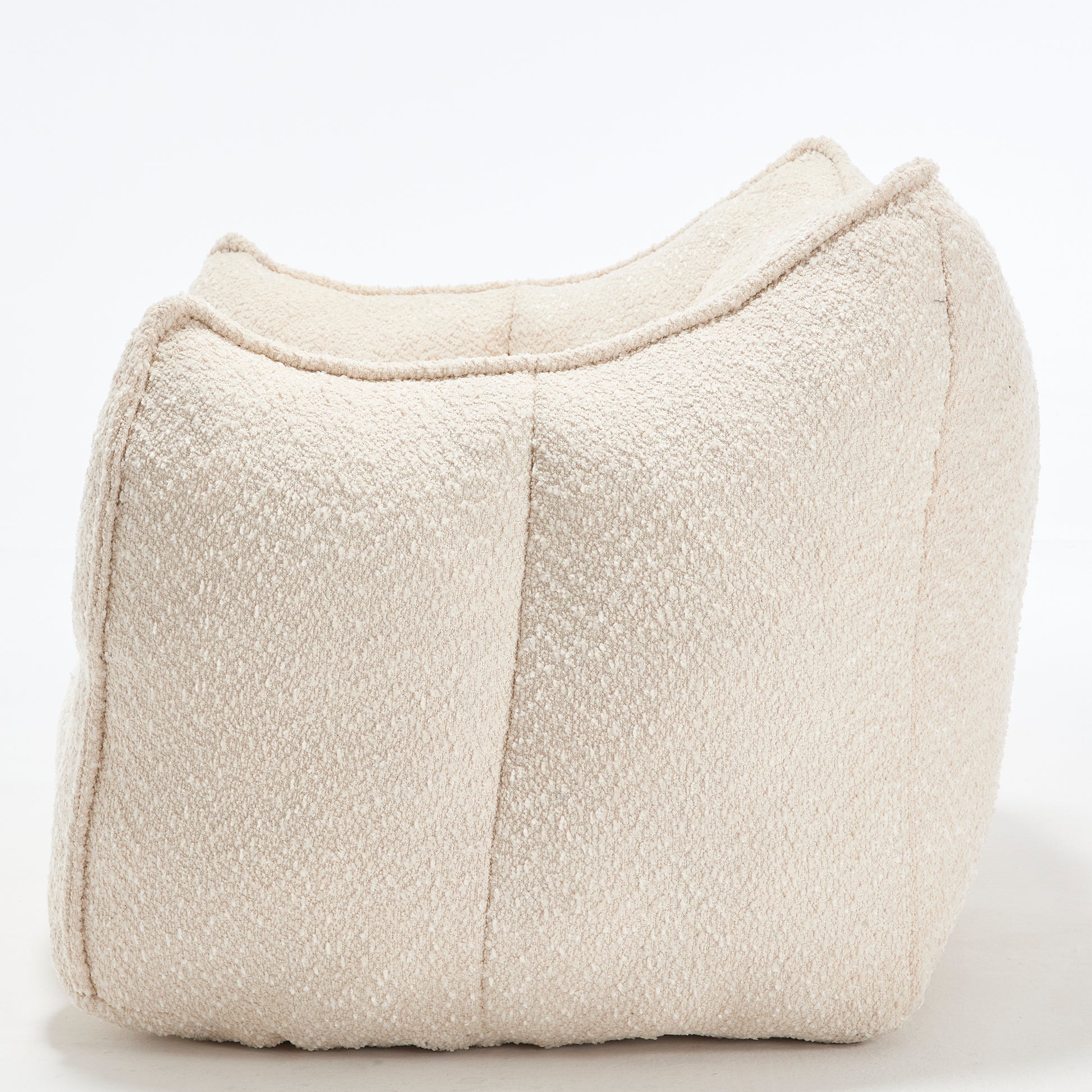 Curved boucle fabric ottoman in cream a versatile accent piece for any living space