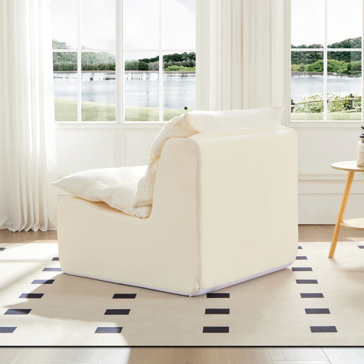 Plush cream armchair with textured fabric and a large soft pillow for ultimate comfort