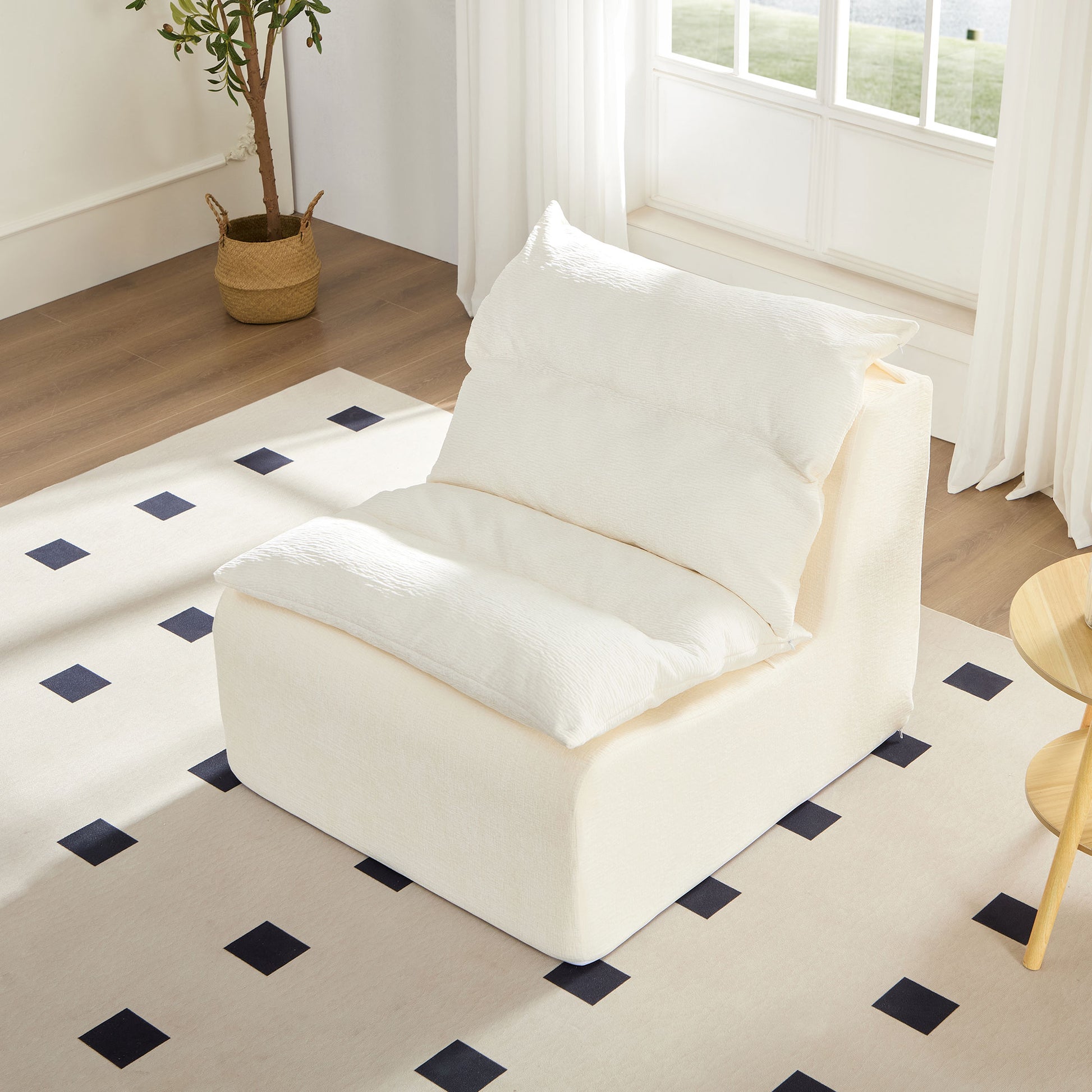 Plush cream modular sofa armless chair with textured cushions