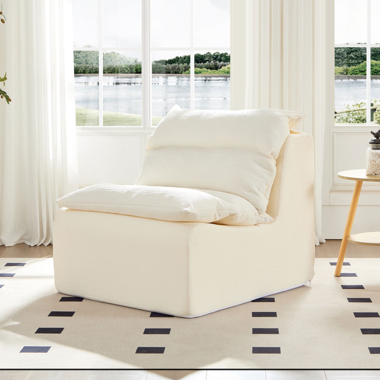 Plush cream accent chair with textured fabric and matching oversized pillows perfect for a cozy reading nook