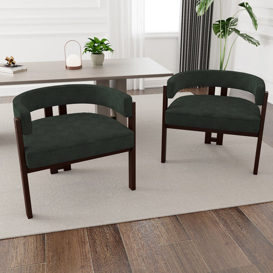 Two dark green fabric armchair chairs with dark wood frames in a dining room setting